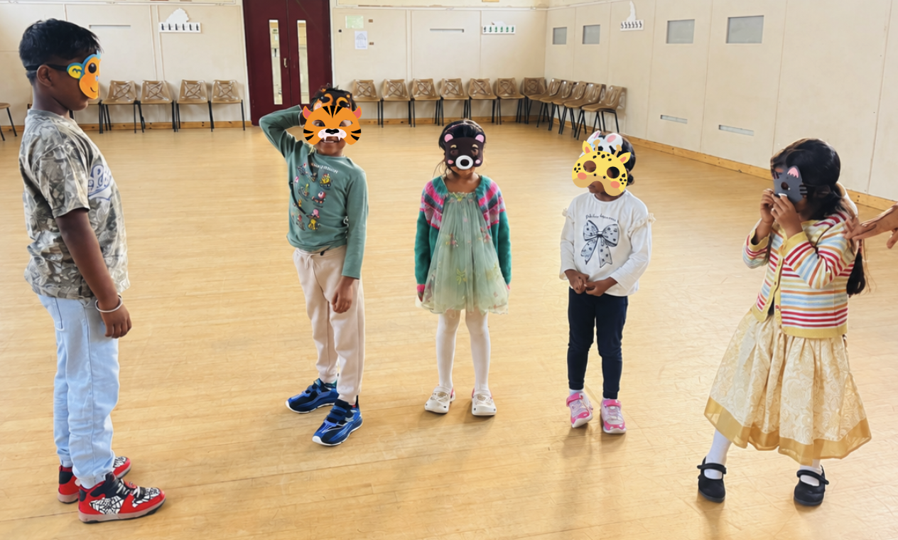 Children in animal masks acting together during a school activity