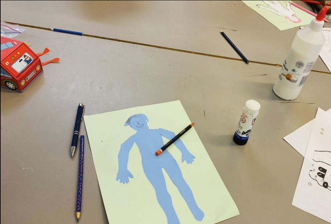 Creative Tamil learning activity with paper, pencils, and craft materials