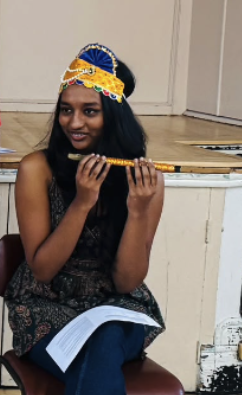 Learner holding a flute during a school cultural activity